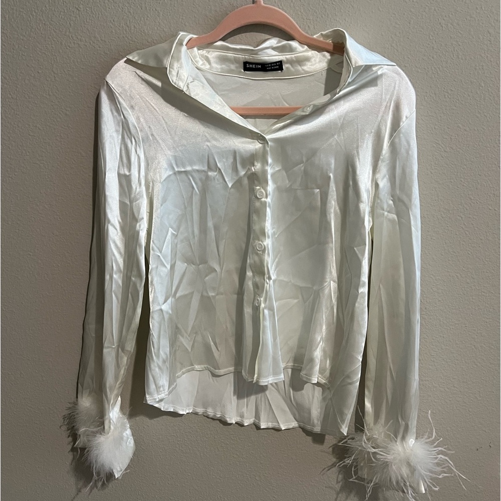 White long sleeve button up with feathers end of sleeve. Brand Shein. Size XS.